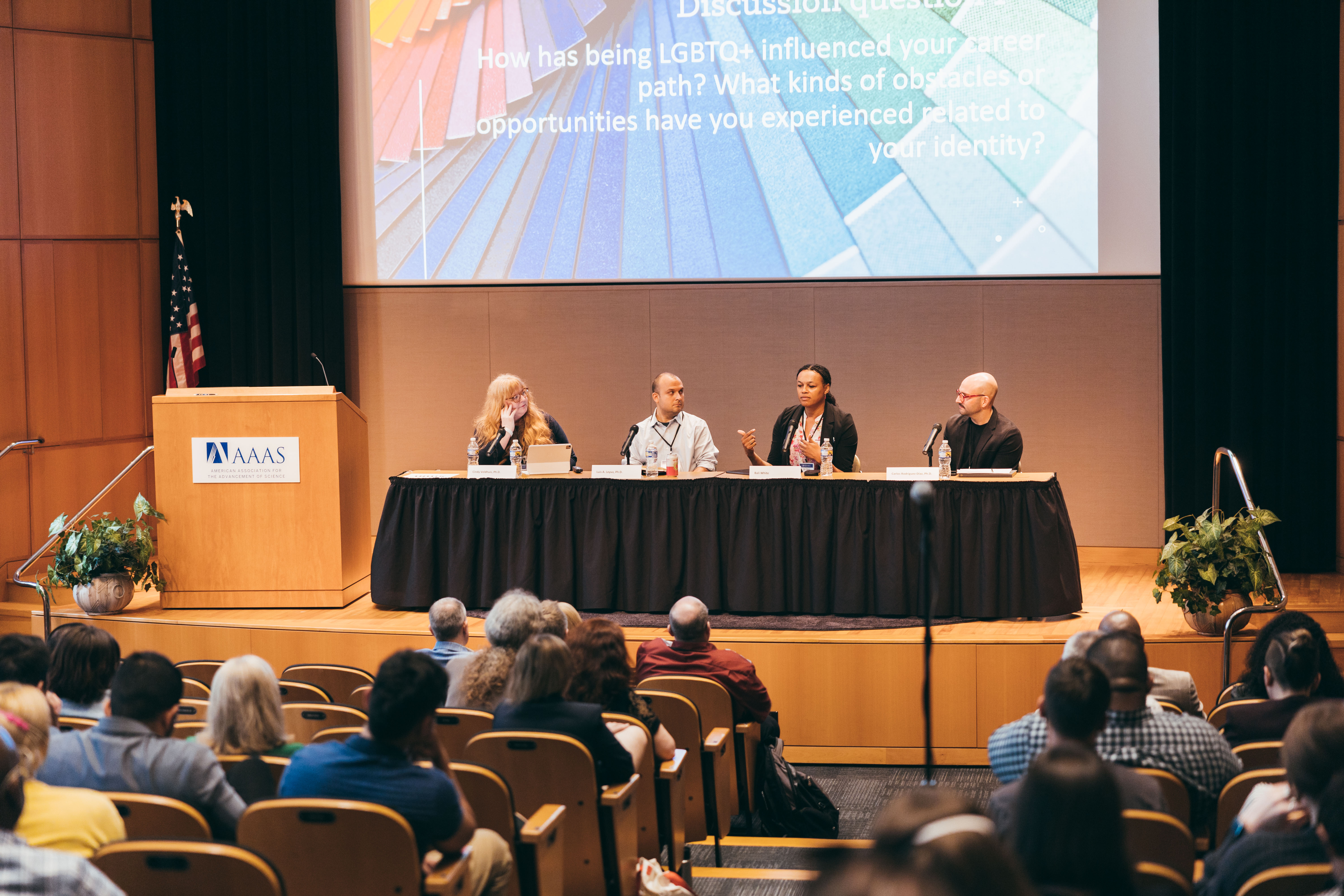 Four panelists sitting behind a table