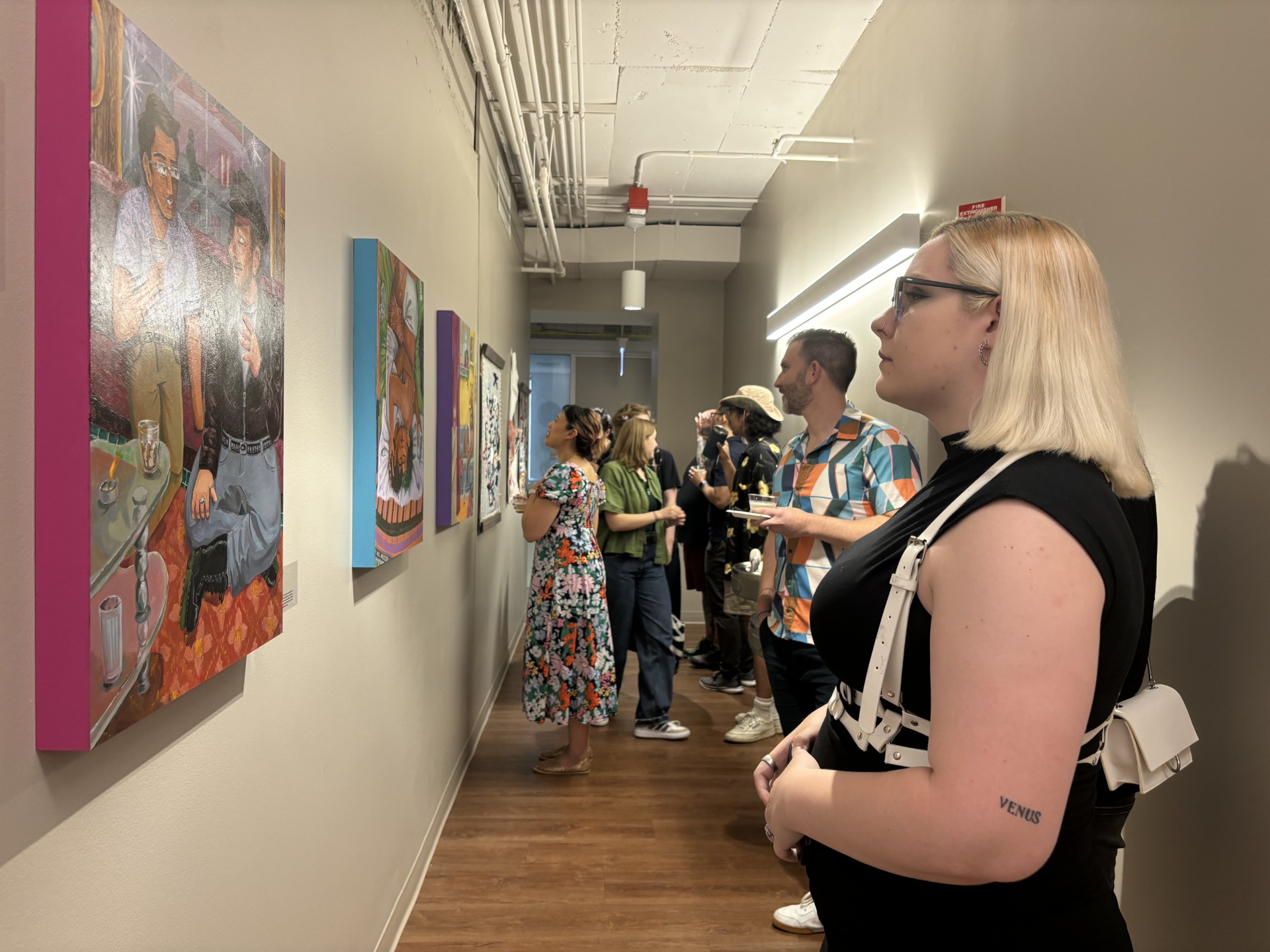 gallery attendees look at art