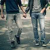 men holding hands and walking