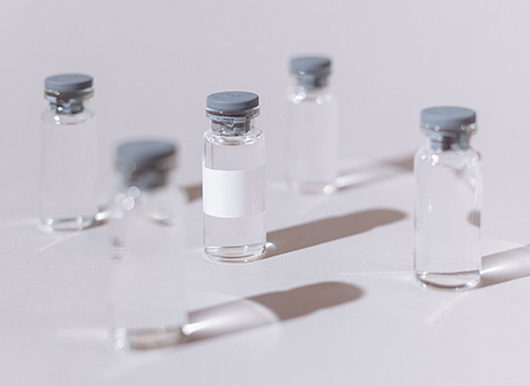 five empty vaccine vials
