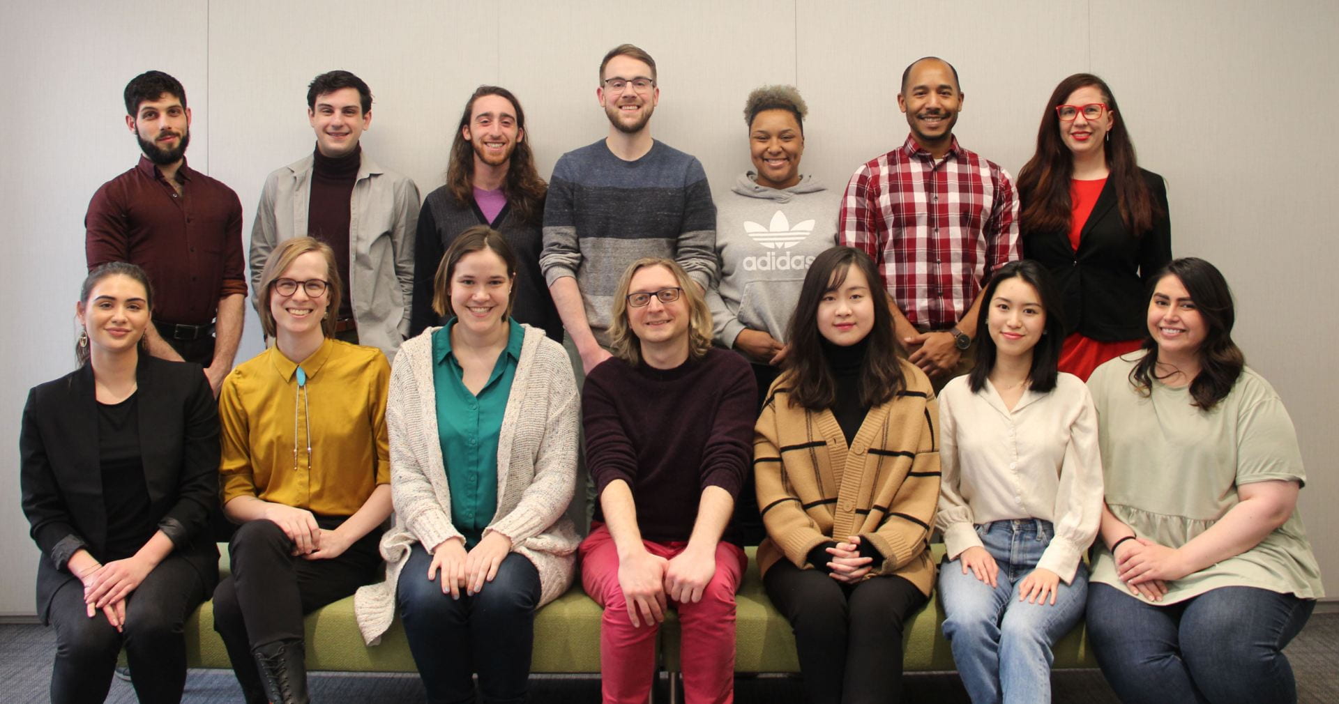 Several faculty and staff members of the EDIT Program team stand and sit in two rows.